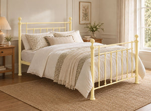 Libham Double Yellow metal bed frame with ornate headboard and footboard.