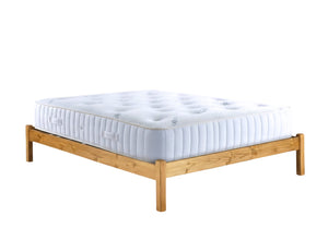 Eco mattress sitting on a wood frame